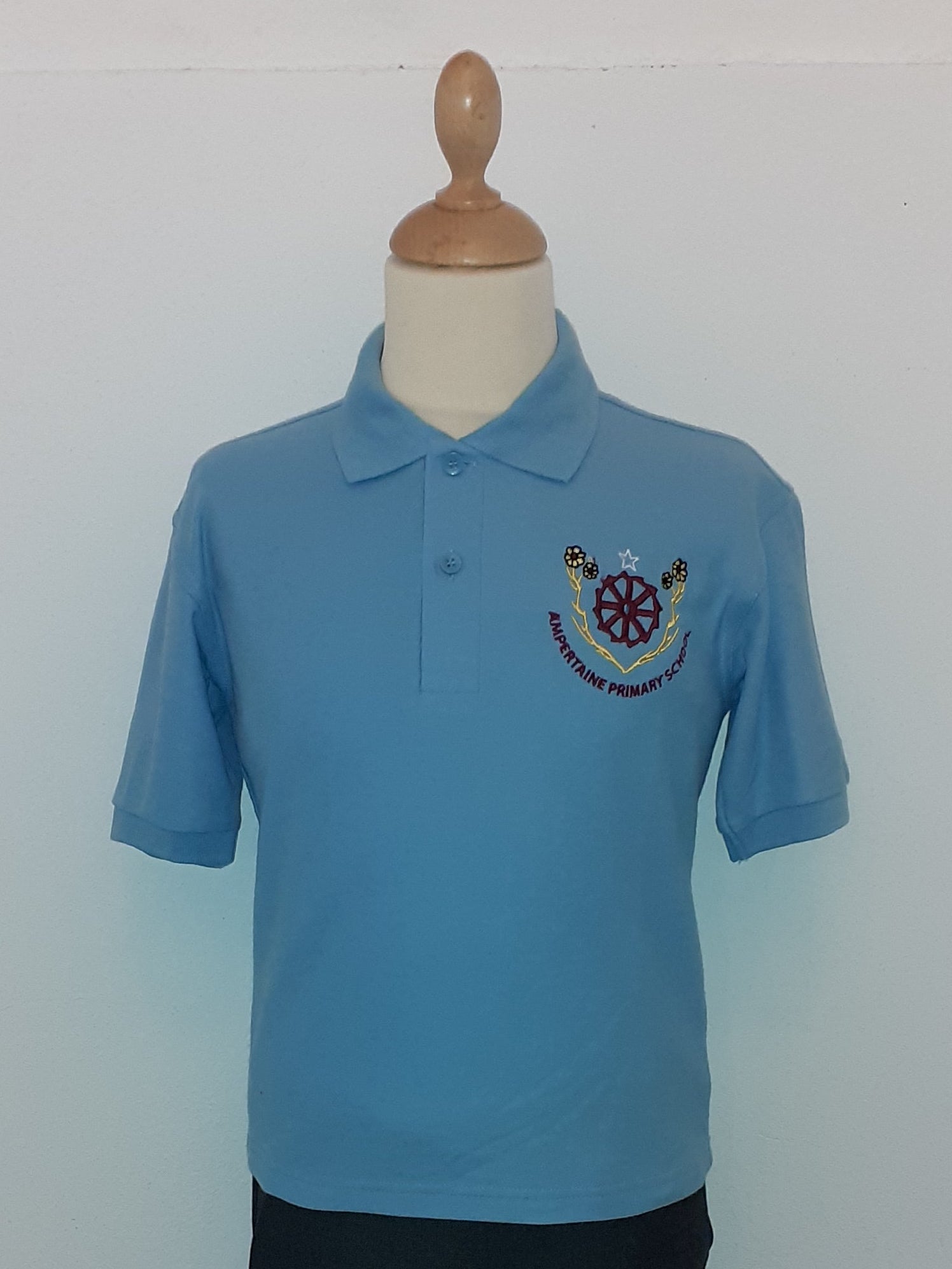 Blue polo shirt son a mannequin against a white wall