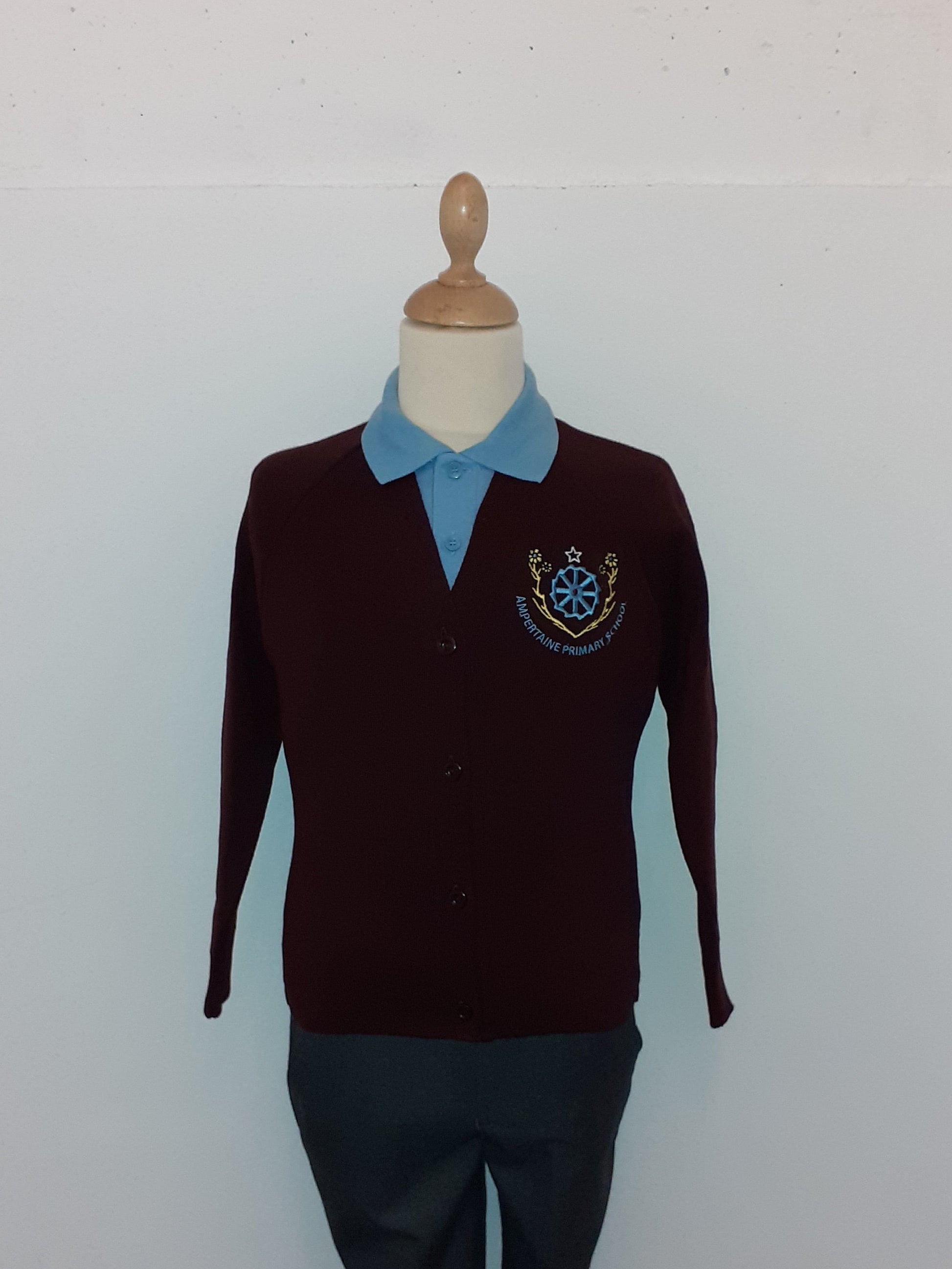 Mannequin wearing a dark sweater with a logo on a white background