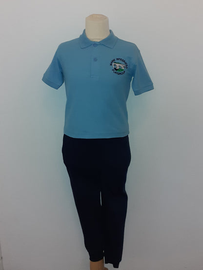 Mannequin wearing a blue shirt and black pants on a white platform with a gray floor.