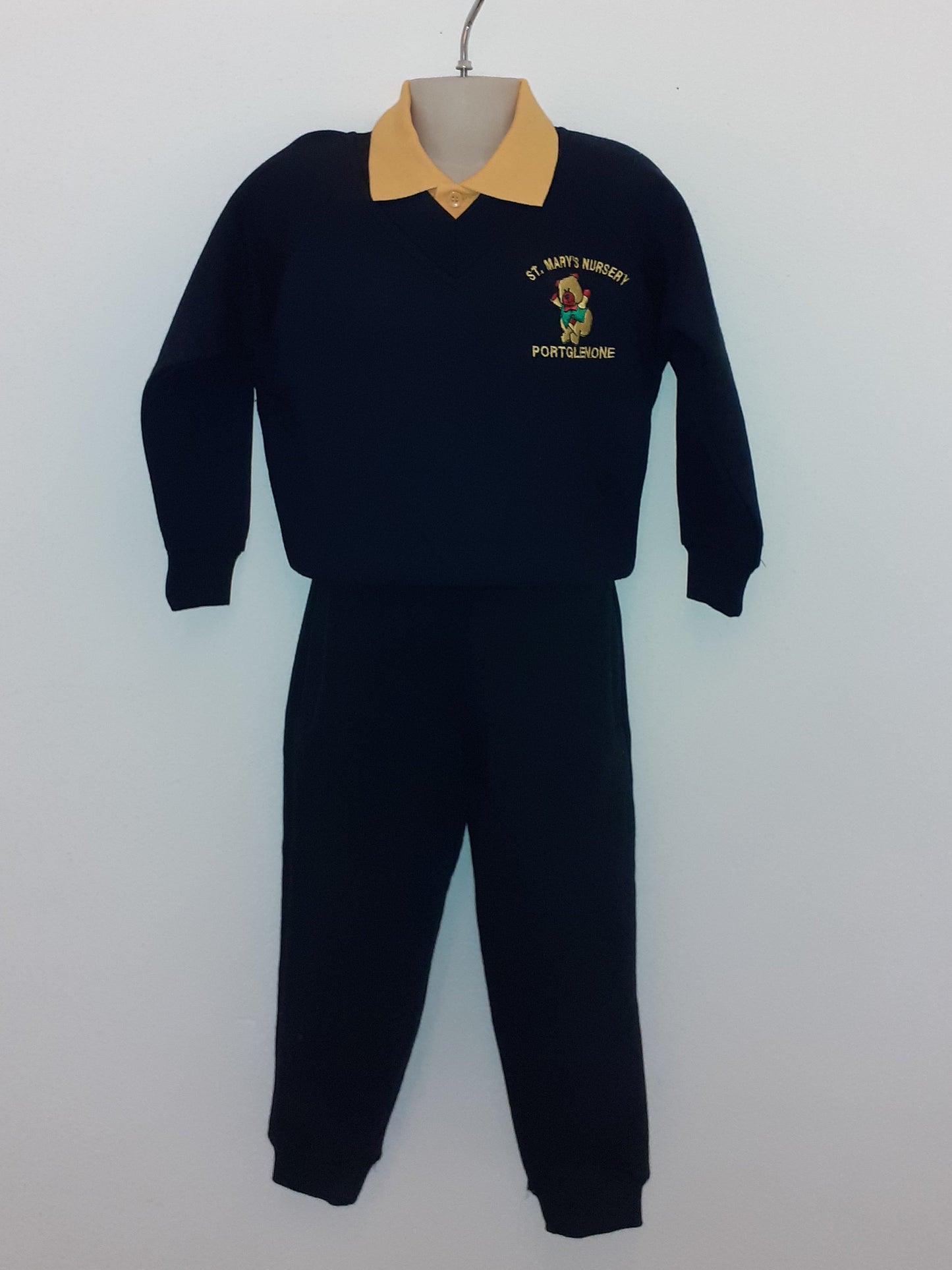 Black outfit with a yellow beanie on a white background