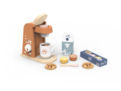 A children's wooden play coffee set on a white background, including a brown and beige coffee machine, white mug, milk carton, blue coffee box, yellow and brown cups, spoon, and cookies.
