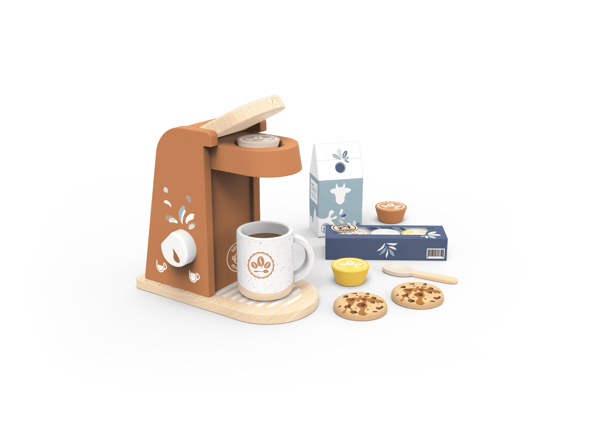 A miniature wooden toy coffee set on a white tray, featuring a brown and beige coffee maker, a white mug with a coffee logo, a milk carton, cookies, and small accessories, isolated on a black background with a white brush-stroke border.