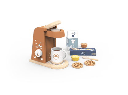 A miniature wooden toy coffee set on a white tray, featuring a brown and beige coffee maker, a white mug with a coffee logo, a milk carton, cookies, and small accessories, isolated on a black background with a white brush-stroke border.