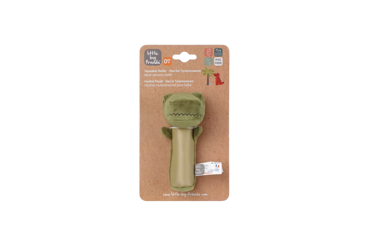 Green dino toy on a cardboard packaging with brand logo