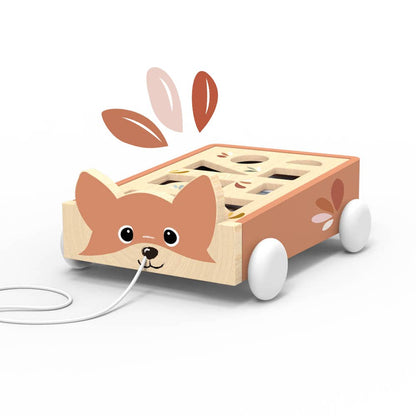 Wooden toy dog with wheels and a string on a white background