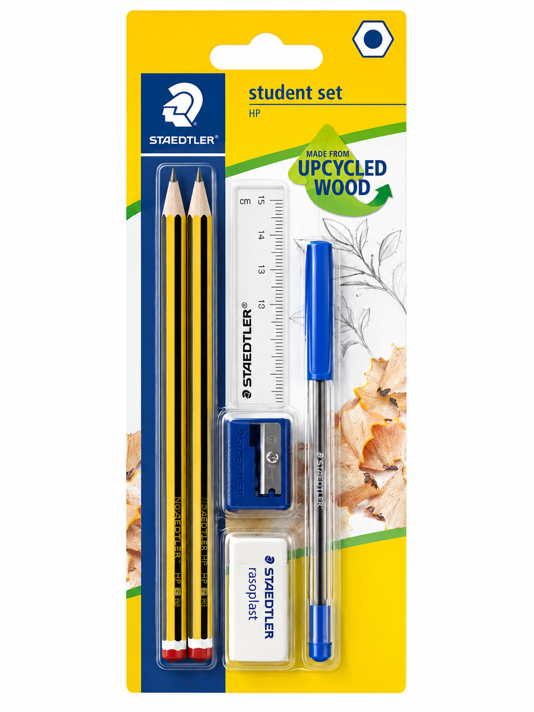 A packaged Staedtler student set containing a yellow pencil, a blue pen, a ruler, a blue sharpener, and an eraser, all attached to a yellow and blue cardboard backing with 'student set' and 'UPCYCLED WOOD' text.